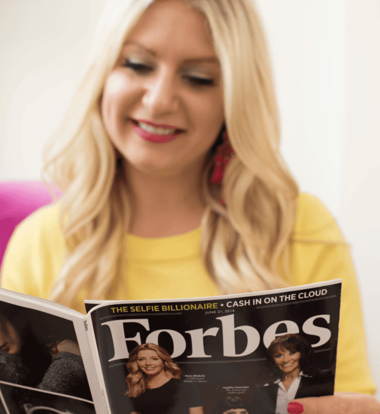 Emily Williams reading Forbes Magazine