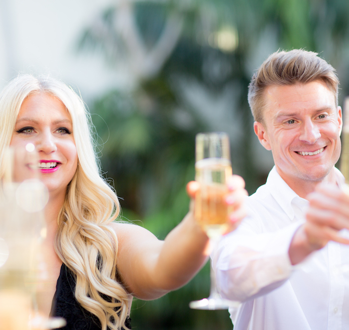 Emily and James Williams cheersing with champagne glasses